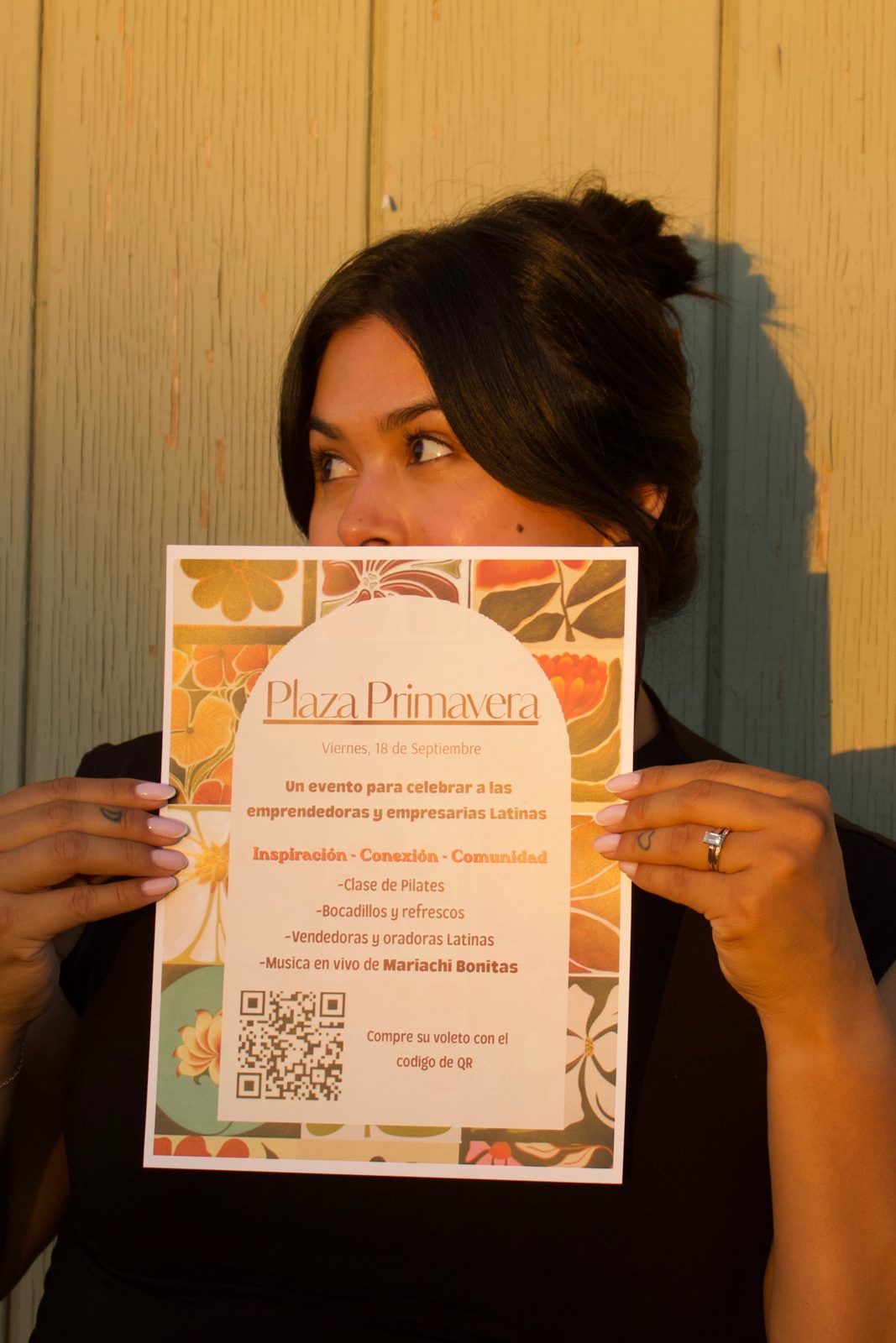 Briana holding the Plaza Primavera sign